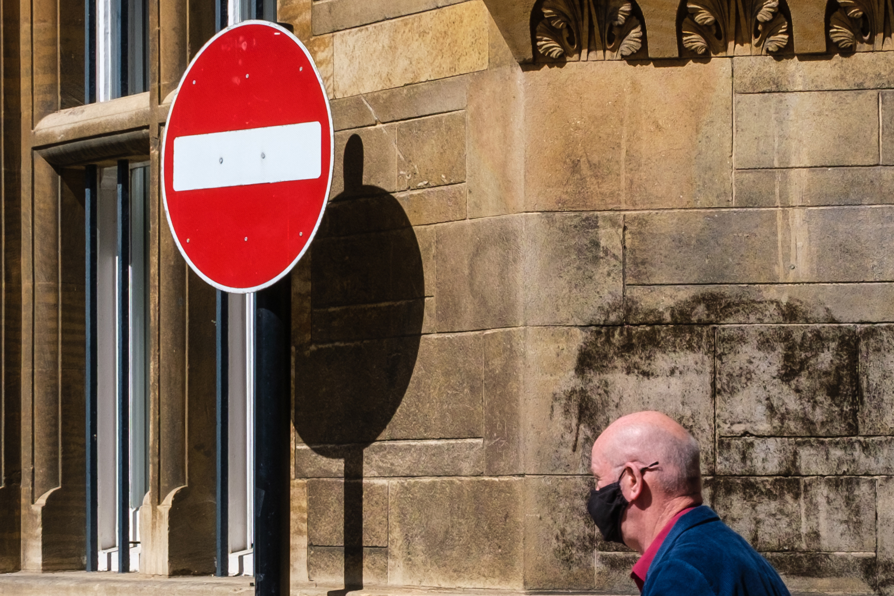 A man walking around a street corner