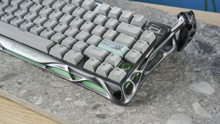 A gray GravaStar Mercury K1 Pro mechanical keyboard, with spider legs