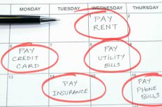 A calendar page with notes to pay rent and utilities.