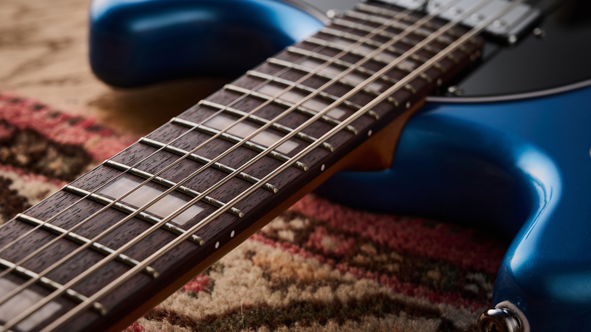 Close up of the rosewood fretboard on a Sterling by Music Man StingRay Baritone guitar
