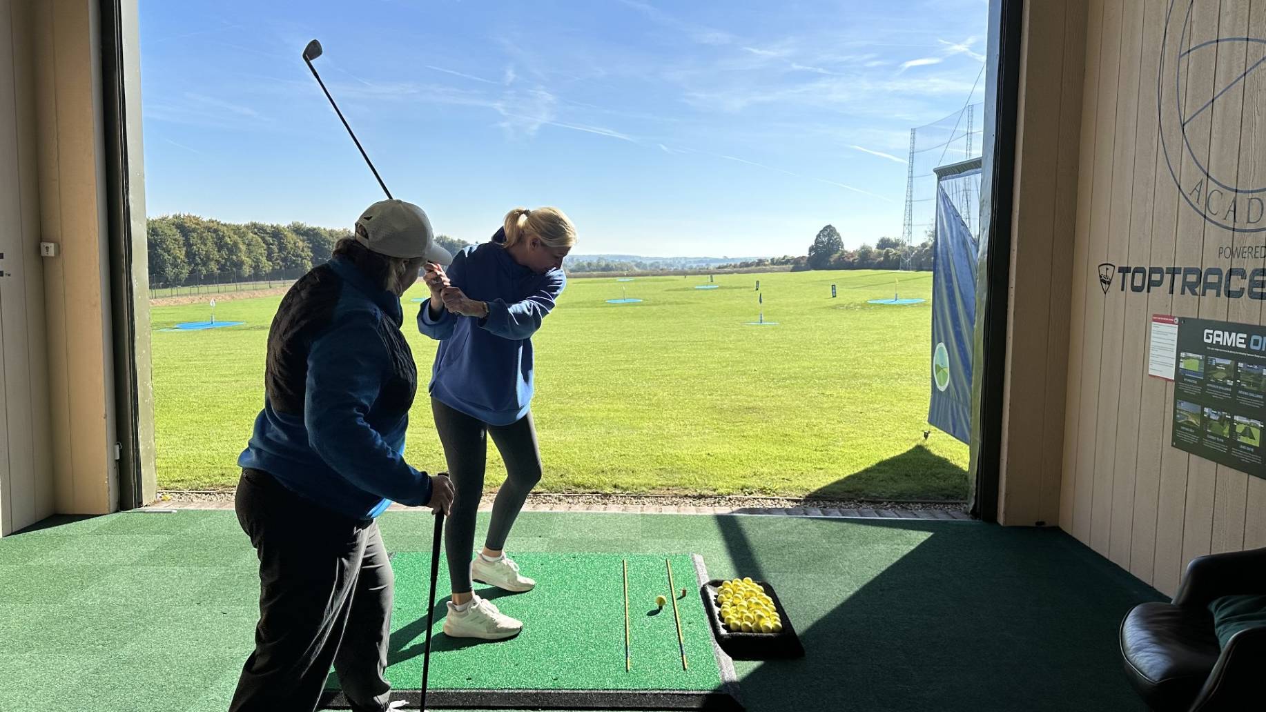 Emma Booth coaching a female golfer