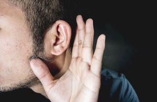 Man straining to hear.