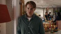 Kit Connor as Nick Nelson, leaning against a door frame at a party in Heartstopper Forever.