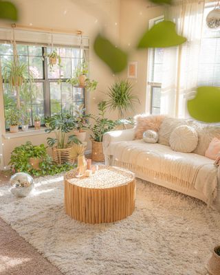Bright bohemian living room with high pile area rug, neutral decor and hanging houseplants, and a disco wall in the center
