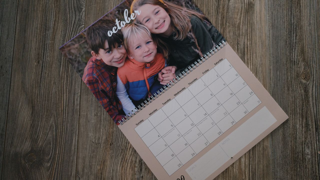 A photo calendar from Vistaprint on a wood background