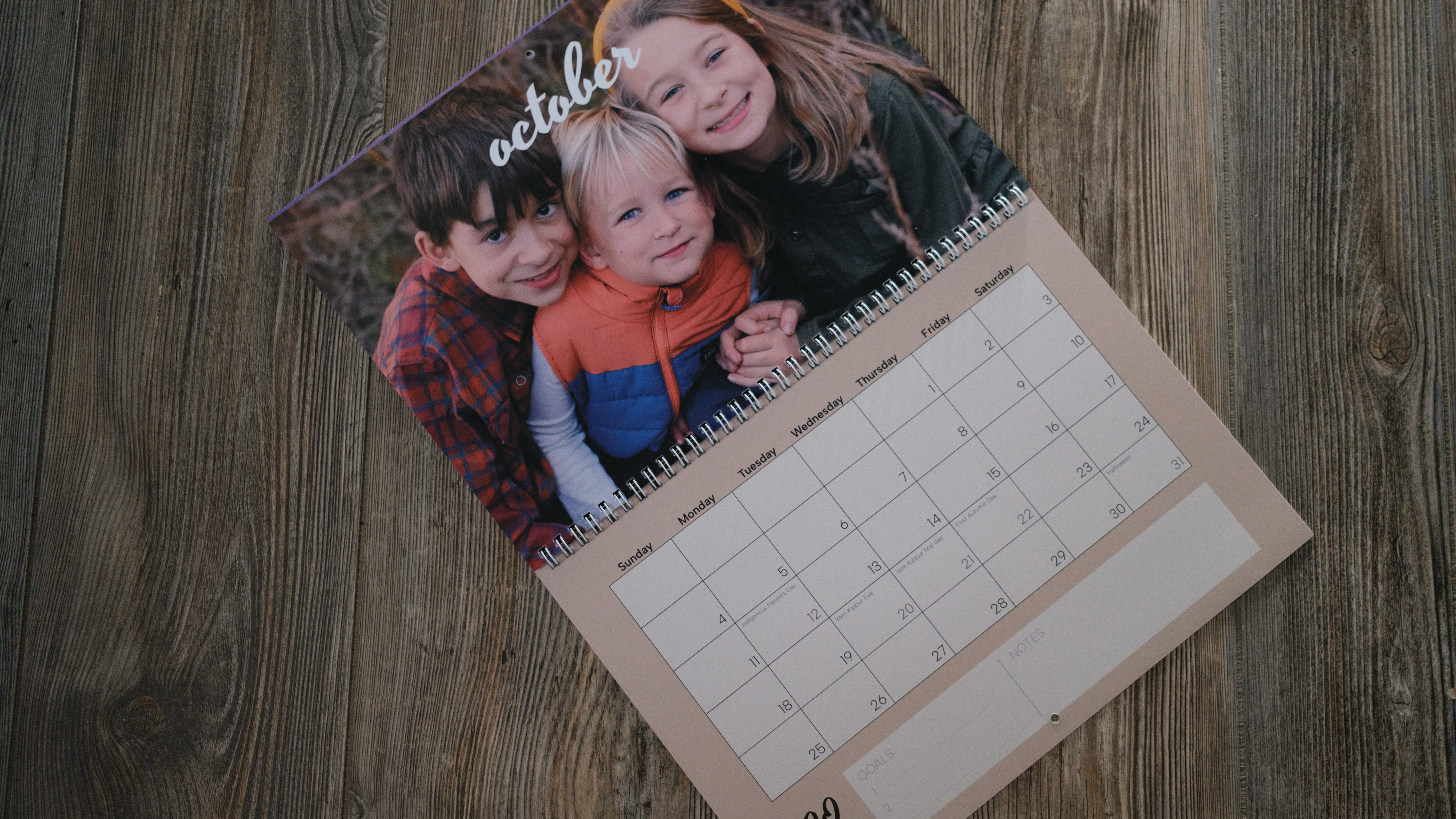 A photo calendar from Vistaprint on a wood background