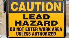 Yellow lead hazard sign with black text.
