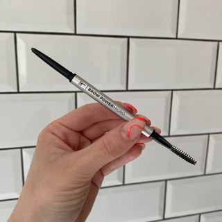 Original image showing hand holding the IT Cosmetics Brow Power Micro pencil