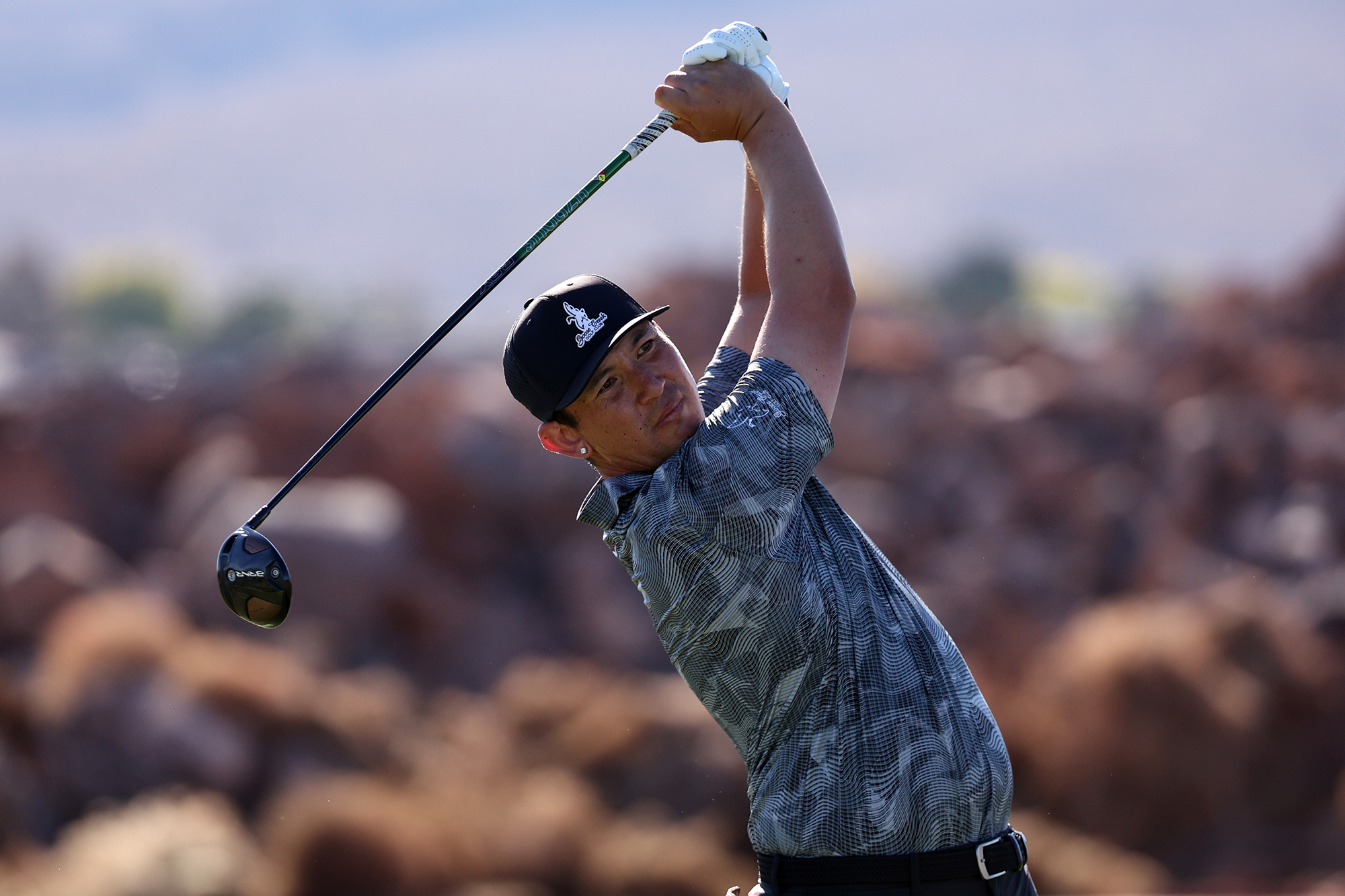 Rico Hoey in the finish position with driver after hitting a tee shot on the golf course