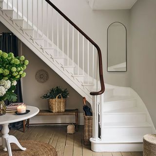 Staircase with arch mirror on wall