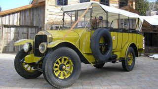 Vintage Yellowstone National Park tour bus with yellow livery