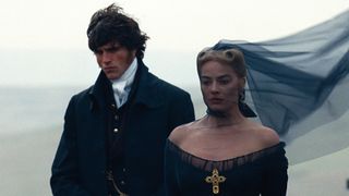 L-R: Heathcliff (Jacob Elordi) and Catherine Earnshaw (Margot Robbie) in funeral attire in a scene from Emerald Fennell's "Wuthering Heights"