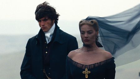 L-R: Heathcliff (Jacob Elordi) and Catherine Earnshaw (Margot Robbie) in funeral attire in a scene from Emerald Fennell's "Wuthering Heights"