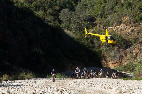 The media helicopter hovers over the riders