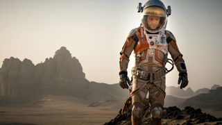 Matt Damon as Dr. Mark Watney walking on an alien planet during The Martian, one of the best movies on HBO Max.