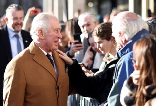 Prince Charles, Prince of Wales greets members of the public as he visits Cambridge Market on November 23, 2021