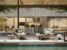 Patio next to swimming pool displaying Dedons furniture collection