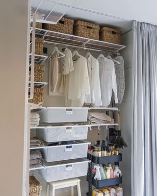 Organized closet with black rolling cart