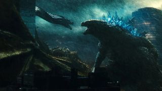 Scene from Godzilla: King of the Monsters (2019). Here we see Godzilla, a giant lizard monster, facing off against a giant dragon-like monster during a heavy storm.