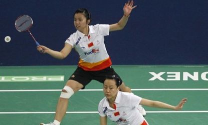 Professional female badminton players wear shorts during a 2011 tournament in Malaysia: The Badminton World Federation will force elite-level women to wear skirts and dresses. 