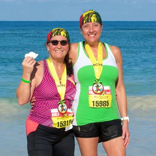 Two people standing in the water who completed the Reggae Marathon