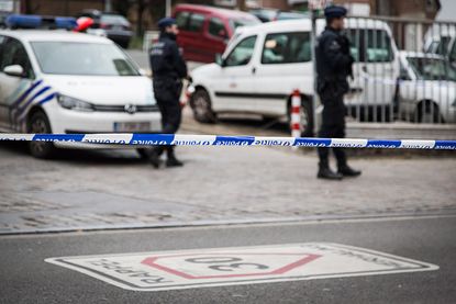 Belgian police officers stand guard after terror suspect Salah Abdeslam was captured in Brussels
