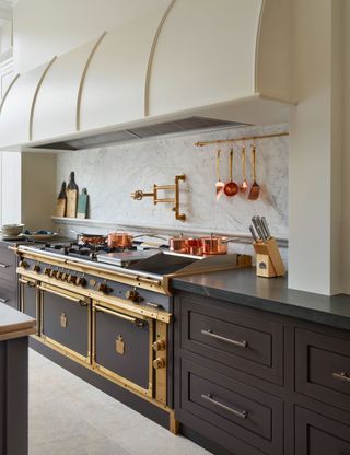 Chef's kitchen with gray cabinets and range cooker