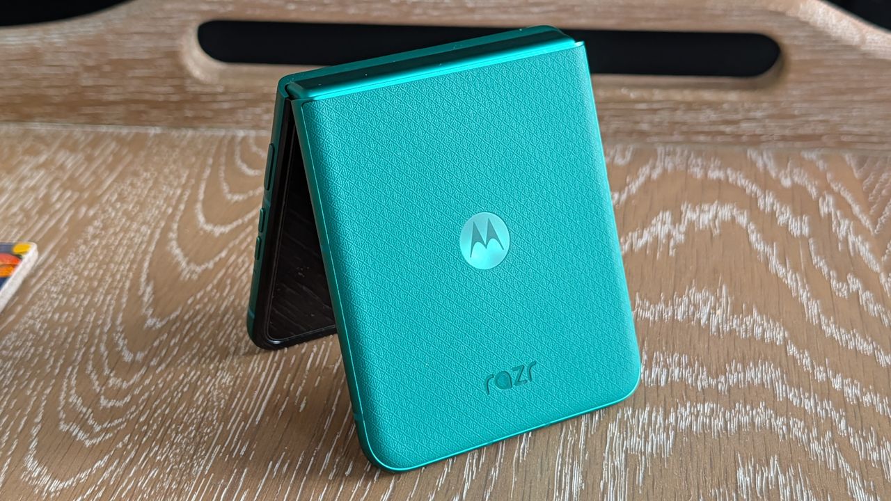 Motorola Razr 2026 in blue, being held in the hand