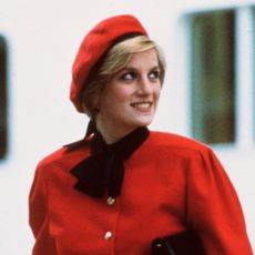 Princess Diana wears a red suit and a matching beret