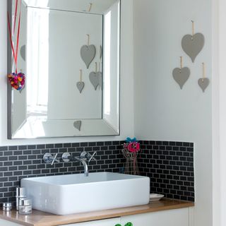 bathroom with white walls and mirror on wall