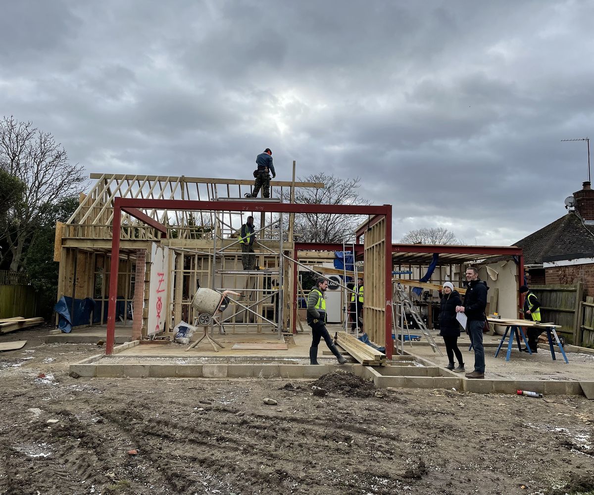 The frame of a new house being laid on foundations