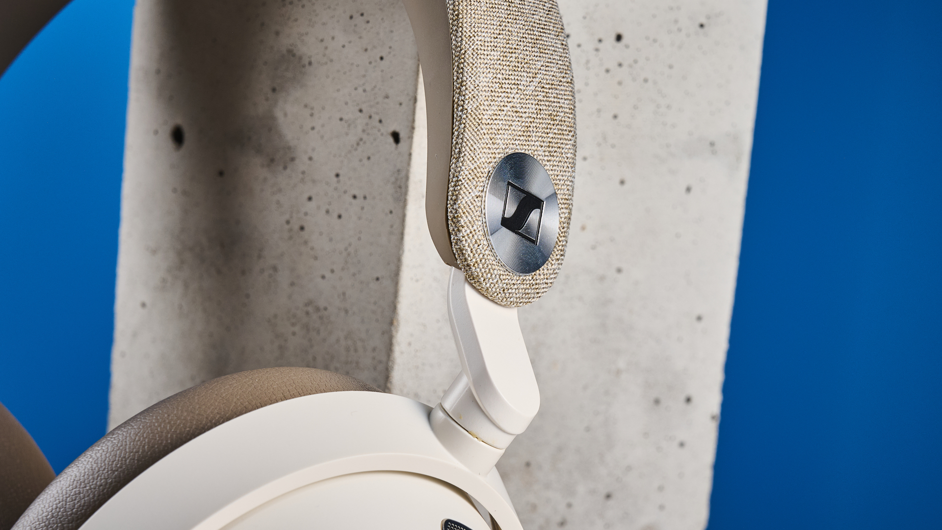 the sennheiser momentum 5 in white photographed against the blue tom's guide background