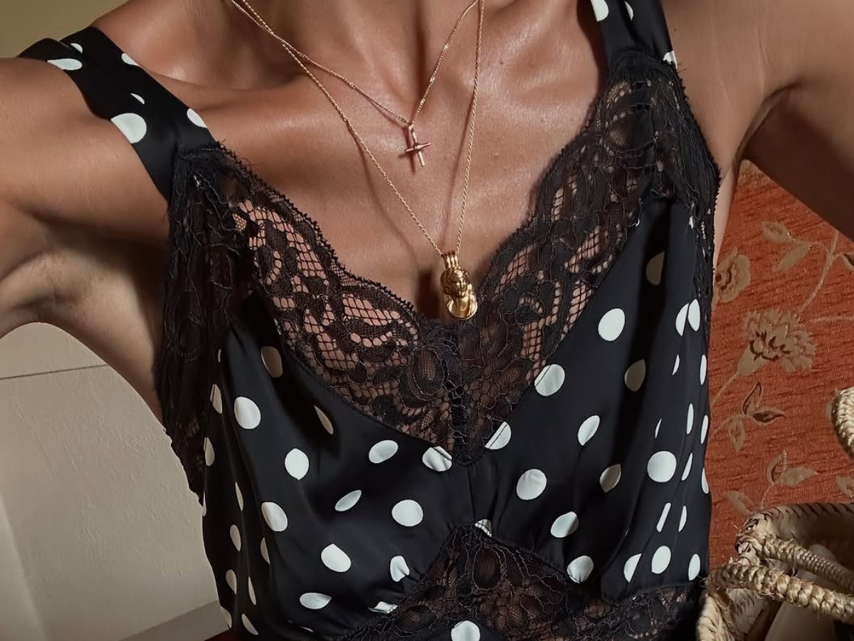 Woman wearing polka dot and lace silk slip dress.