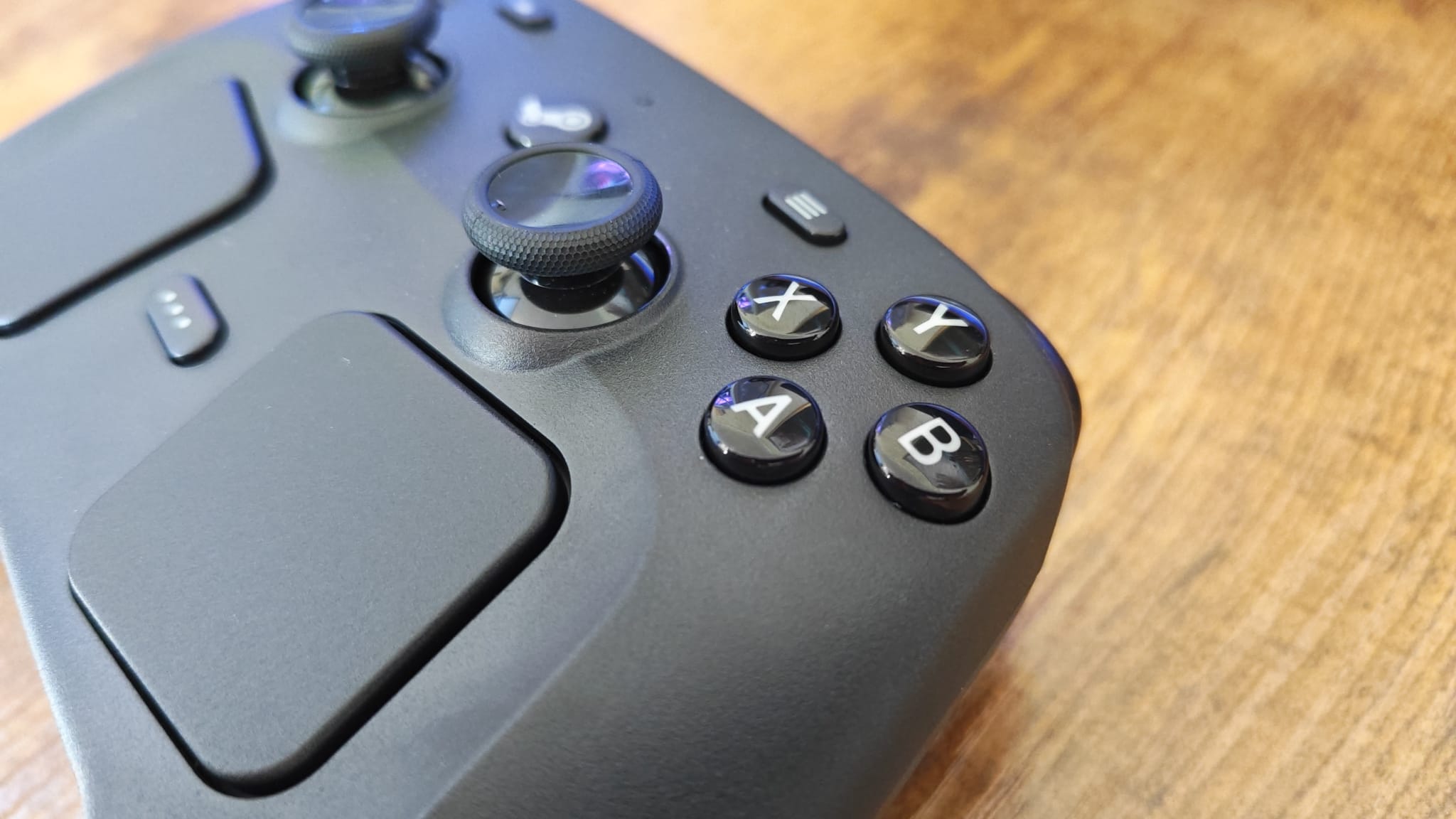 A Steam Controller close up showing the glossy face buttons