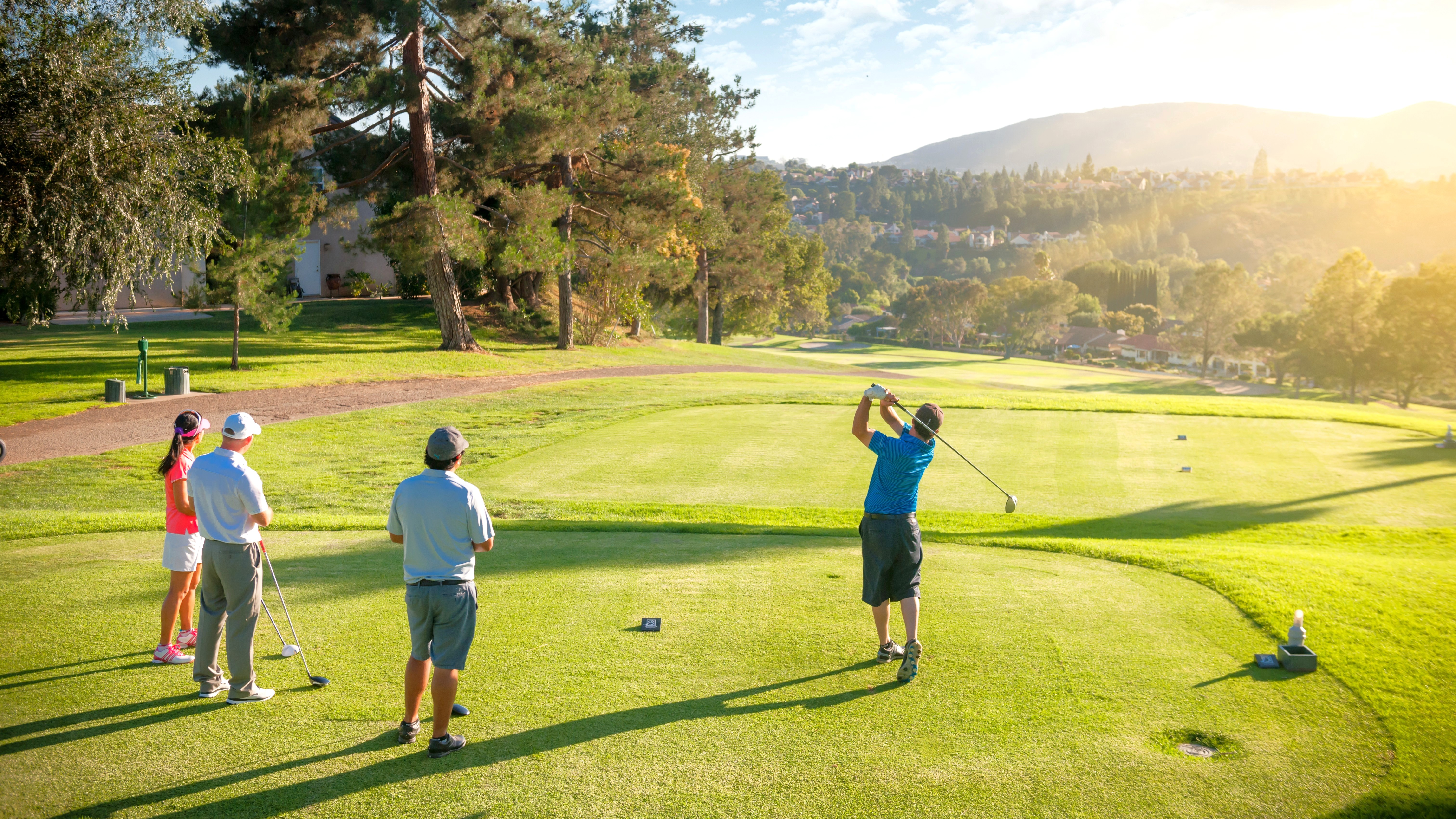 A fourball on the tee, with one of them teeing off