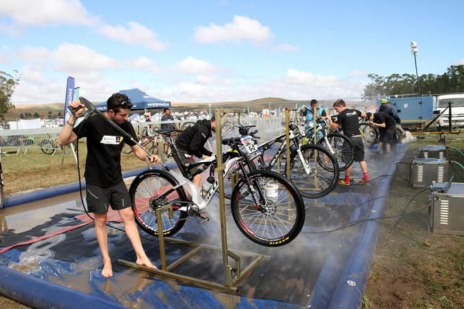 Team Mechanics clean the bikes after a hard stage