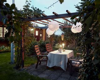 garden pergola with lanterns and table set-up