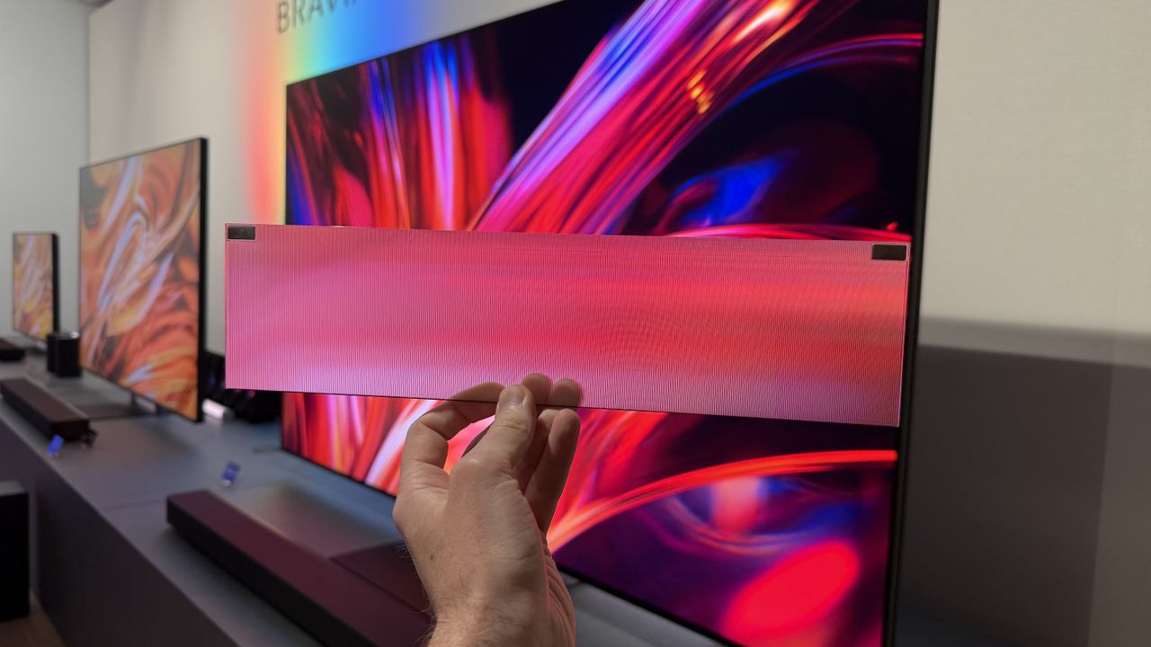 The Sony Bravia 9 II TV's translucent stand material being held in front of the TV to show how it spreads light