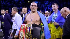 Oleksandr Usyk holds the belts after beating Anthony Joshua in Jeddah 