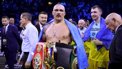Oleksandr Usyk holds the belts after beating Anthony Joshua in Jeddah 