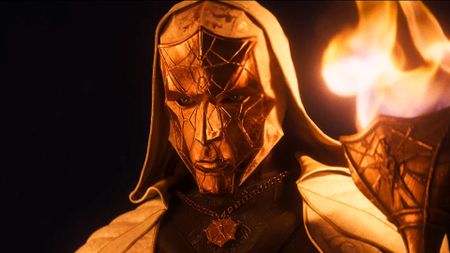 A Divinity character holds a torch to the screen