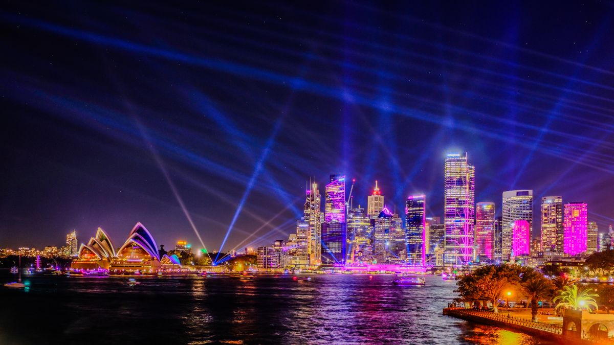 Long exposure of Sydney Harbour buildings lit up with coloured lights during Vivid Sydney