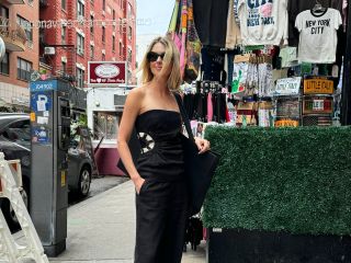 Fashion editor Natalie Cantell on the street in New York City wearing Loewe sunglasses, flat leather Mango flip-flops sandals, the SIR Dorian top with crochet detail, and matching black wide-leg trousers.