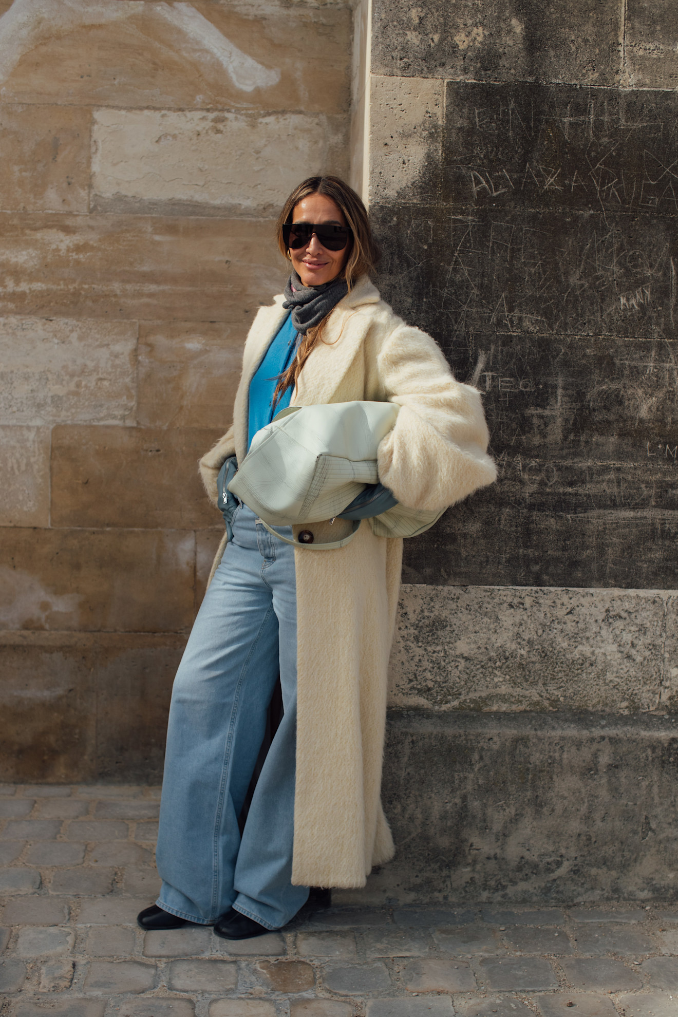 Woman wearing embellished jeans and a black top