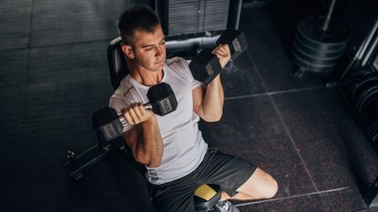 Man doing seated bicep curls