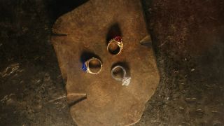 The three elven rings sit on a stone after being forged in The Rings of Power episode 8