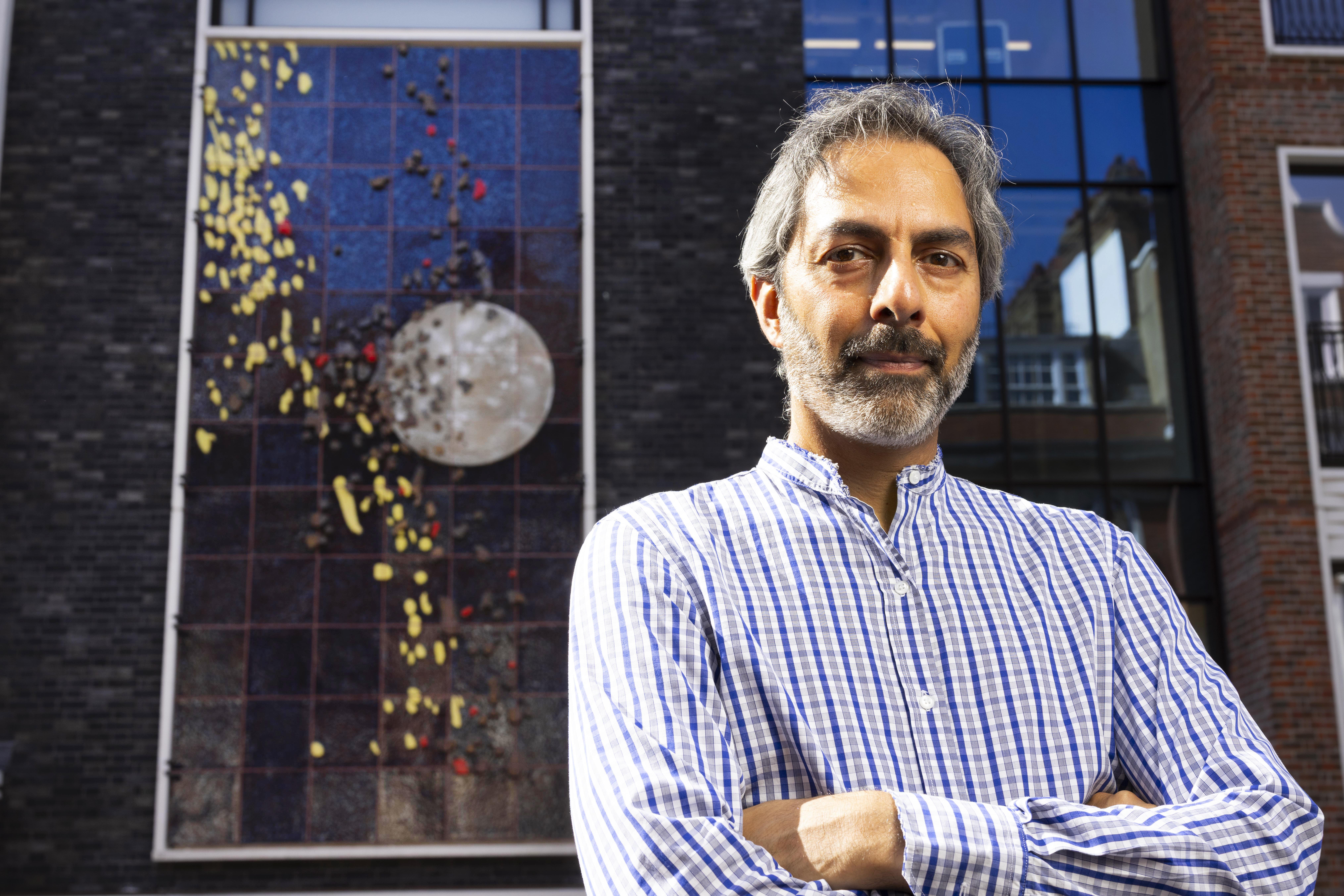 Artist Shezad Dawood at The Gaumont in London, with his artwork Cascade on the façade of the building