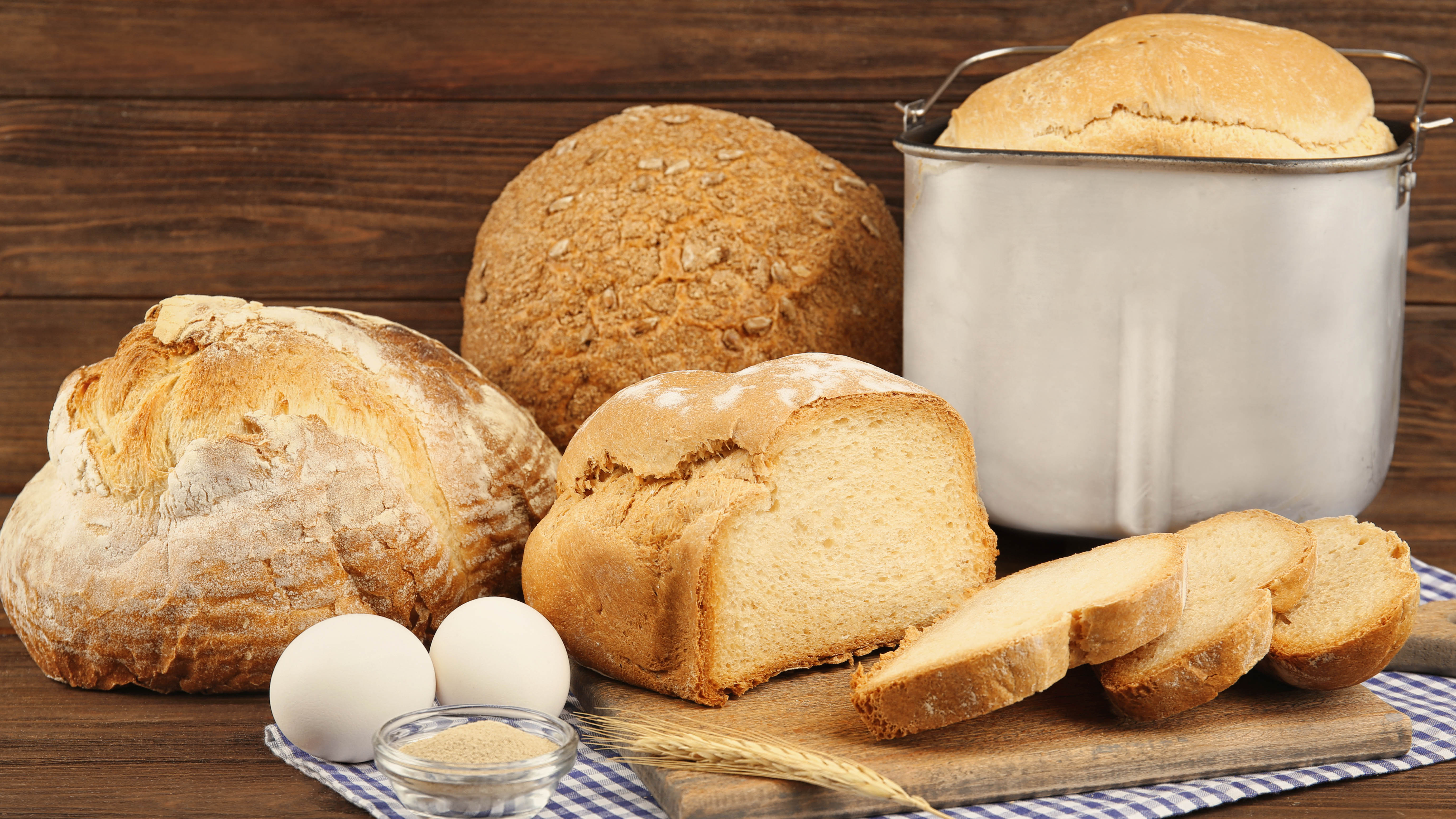 Выбор хлеба рядом с буханкой в ​​кастрюле хлебопечки