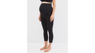 A pregnant woman wearing black maternity leggings for the best leggings on Amazon.