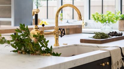 ceramic kitchen sink, marble worktop, brass tap